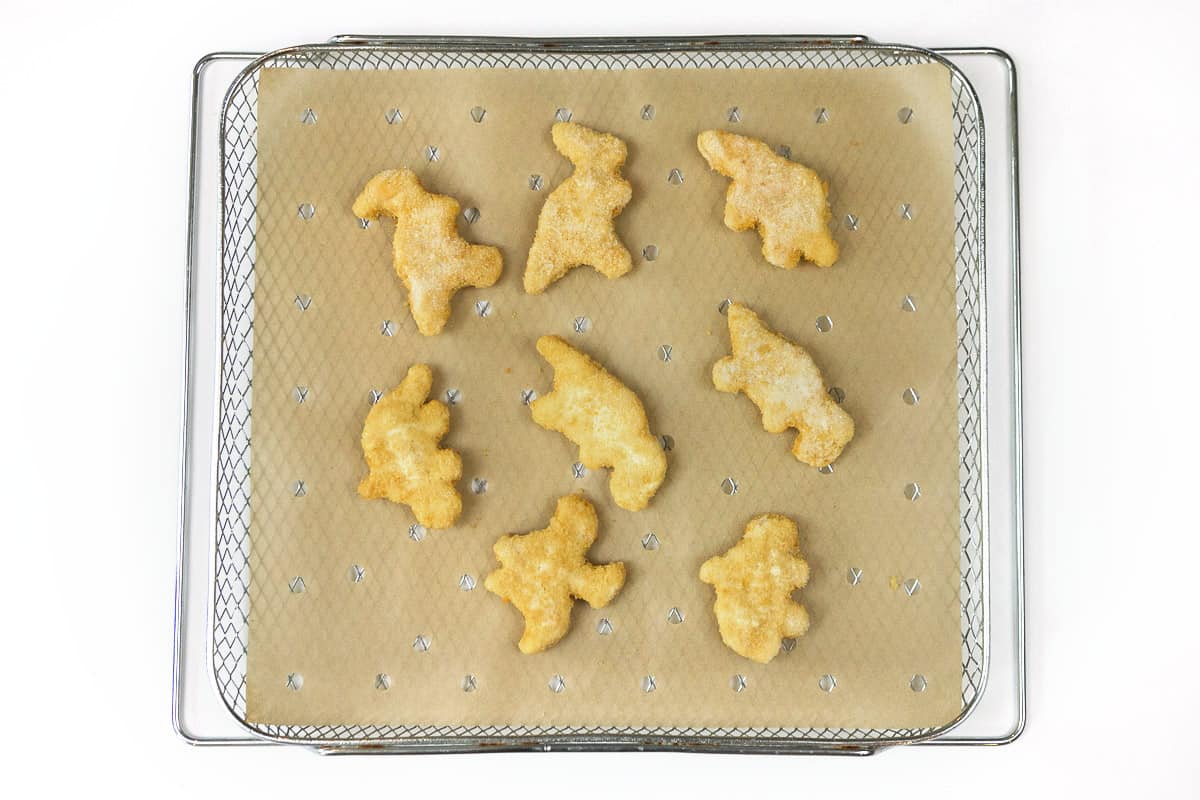 Lay eight nuggets on top of the parchment paper.