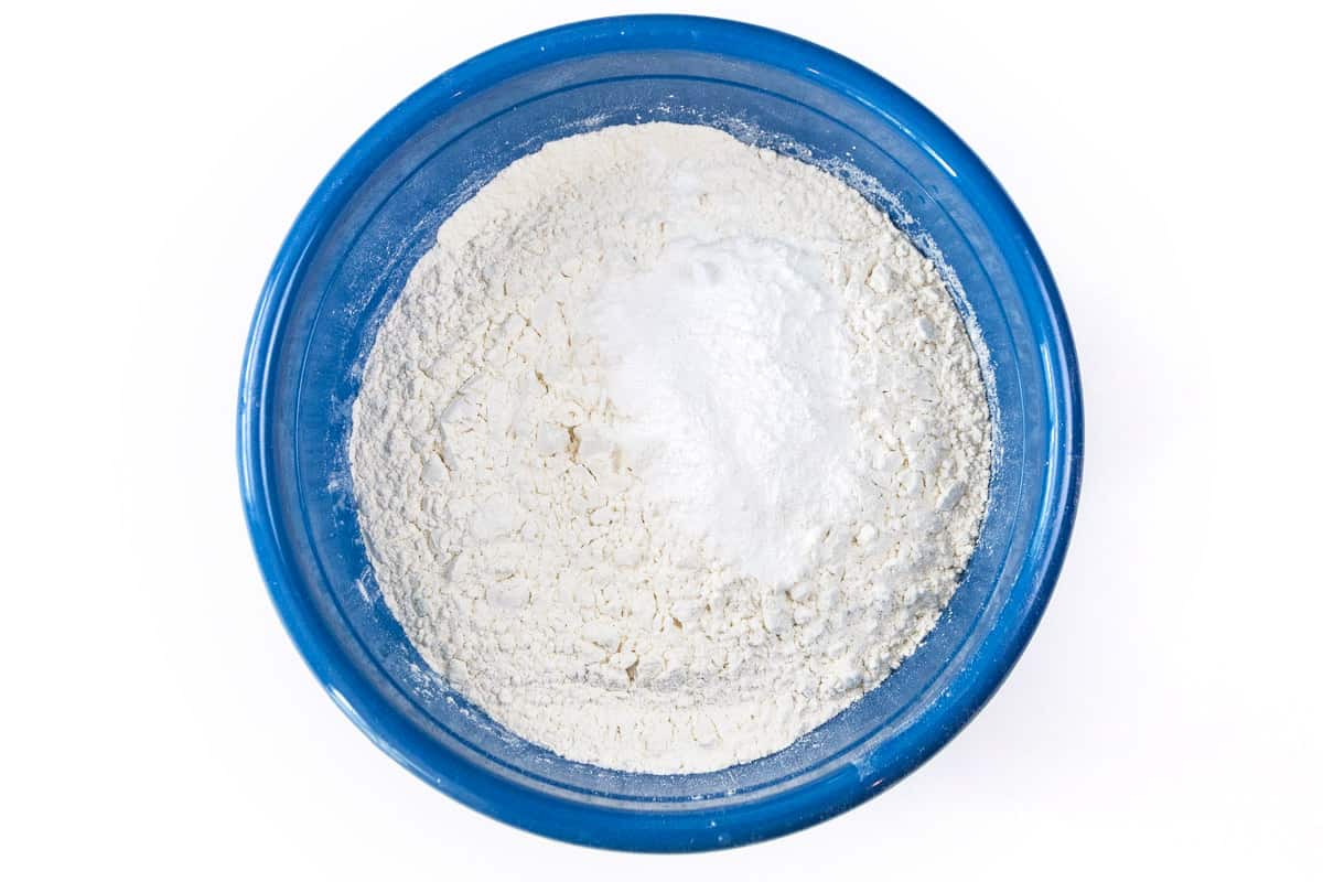 Flour, baking powder, baking soda, and salt in a bowl.