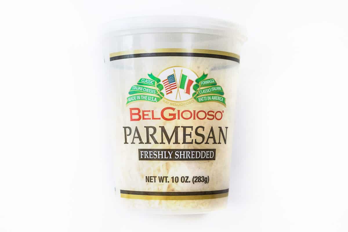 A container of shredded Parmesan cheese.
