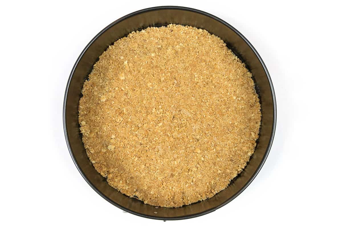 Graham cracker crumbs mixture pressed into a springform pan.