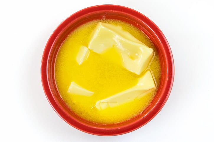 Melted butter in a bowl for sugar cookies.